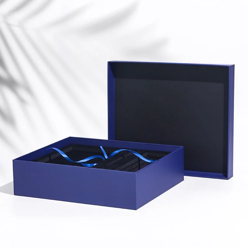 Photograph of a blue rigid gift box with separate lid, fitted insert and ribbon