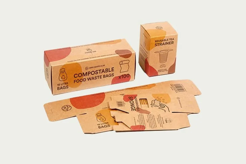 Photograph of printed folding cartons shown assembled alongside flat die-cut blanks